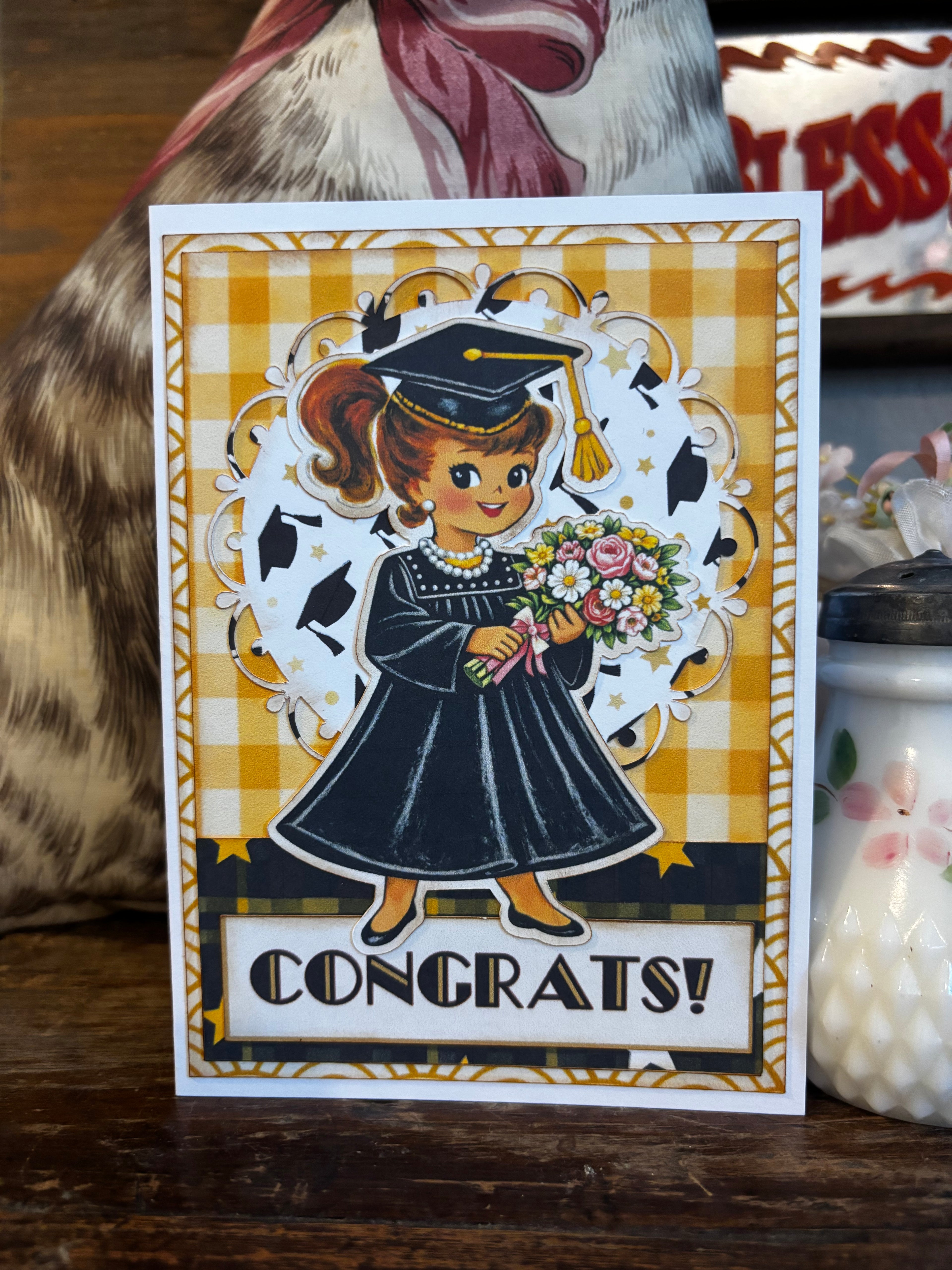 Graduation-themed card with a girl/woman holding flowers. 