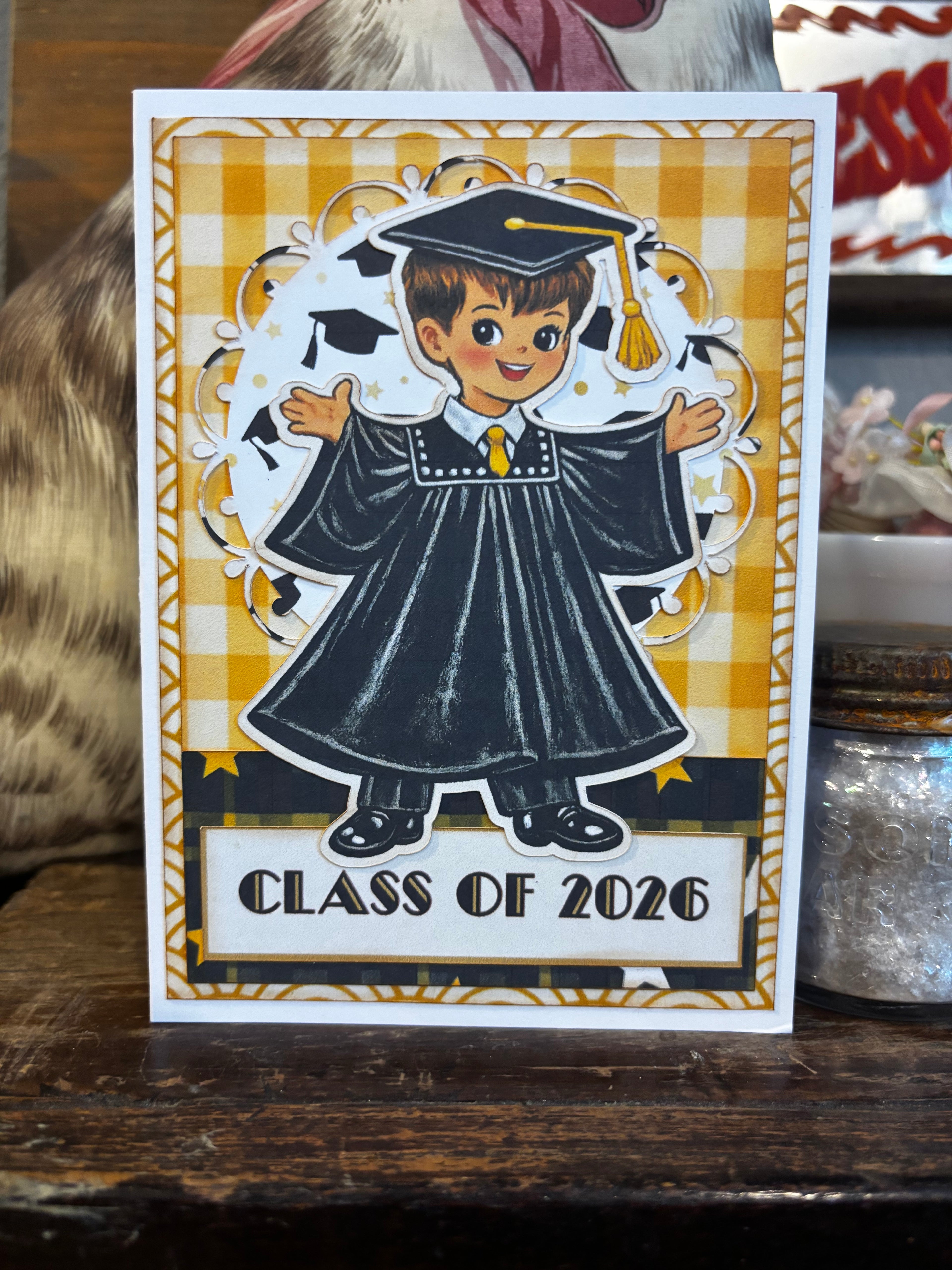 Graduation-themed boy/male card with 'Class of 2026' text on a checkered background