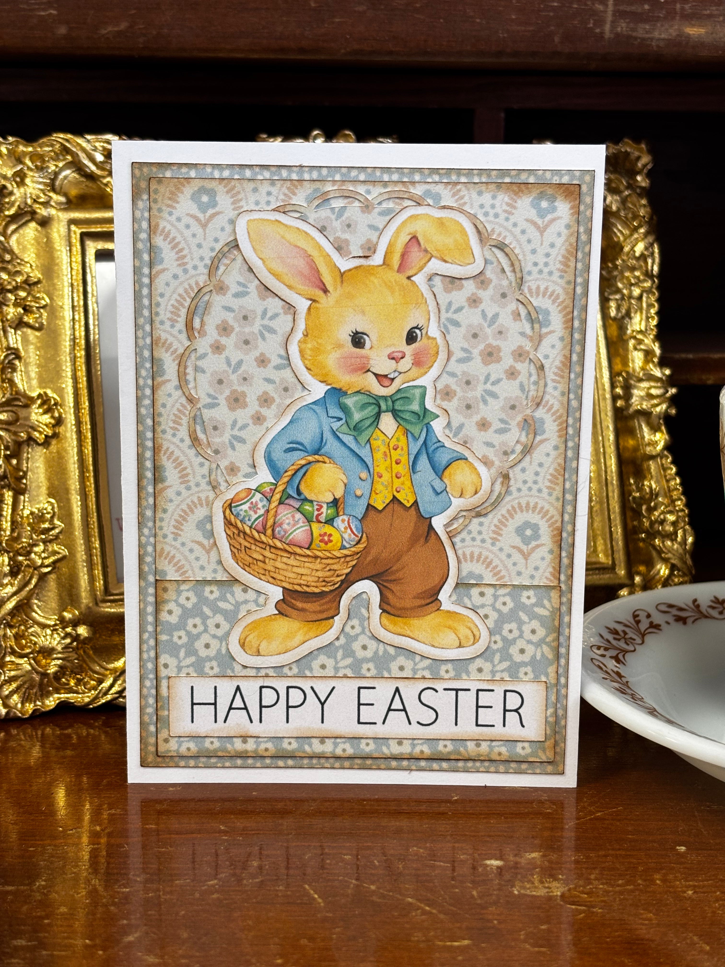 Vintage-style Easter card with a bunny holding a basket of eggs on a wooden surface.