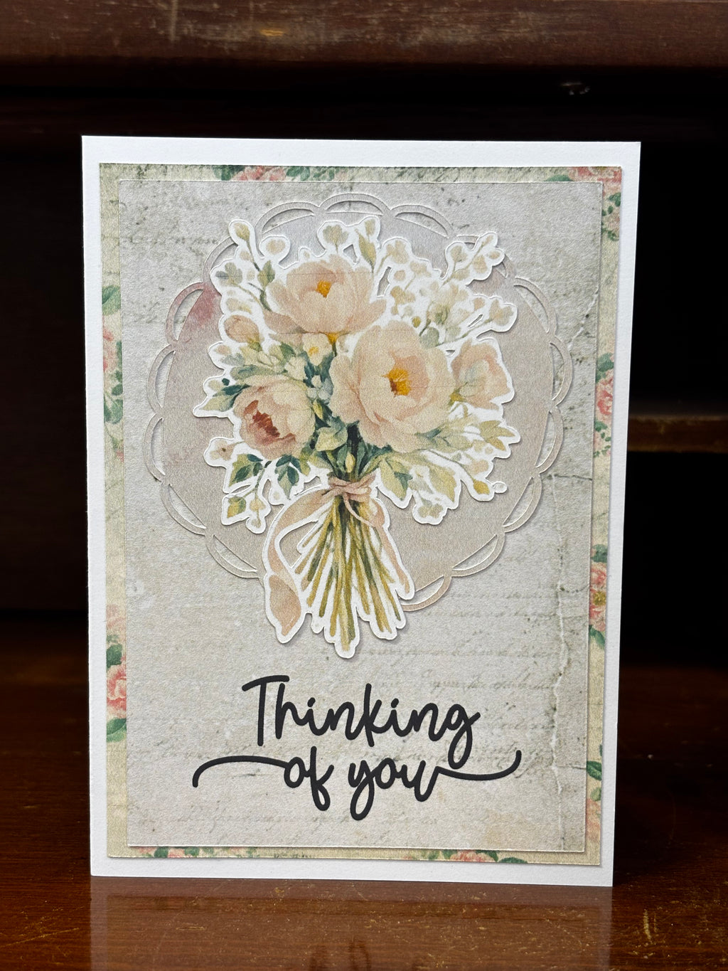 A greeting card with a floral design and 'Thinking of you' text on it.