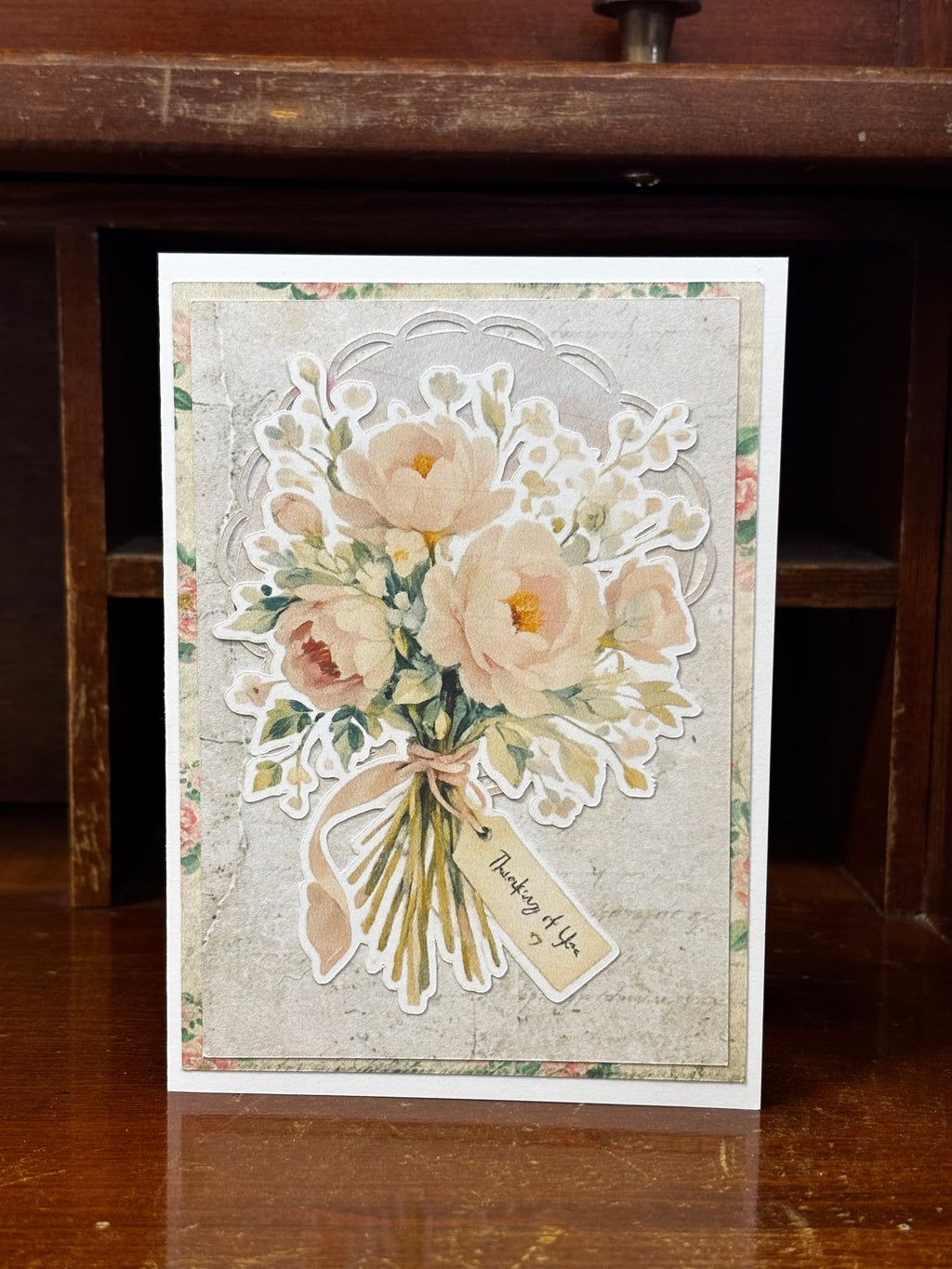 Floral card with a bouquet of flowers with a tag that says "Thinking of you".