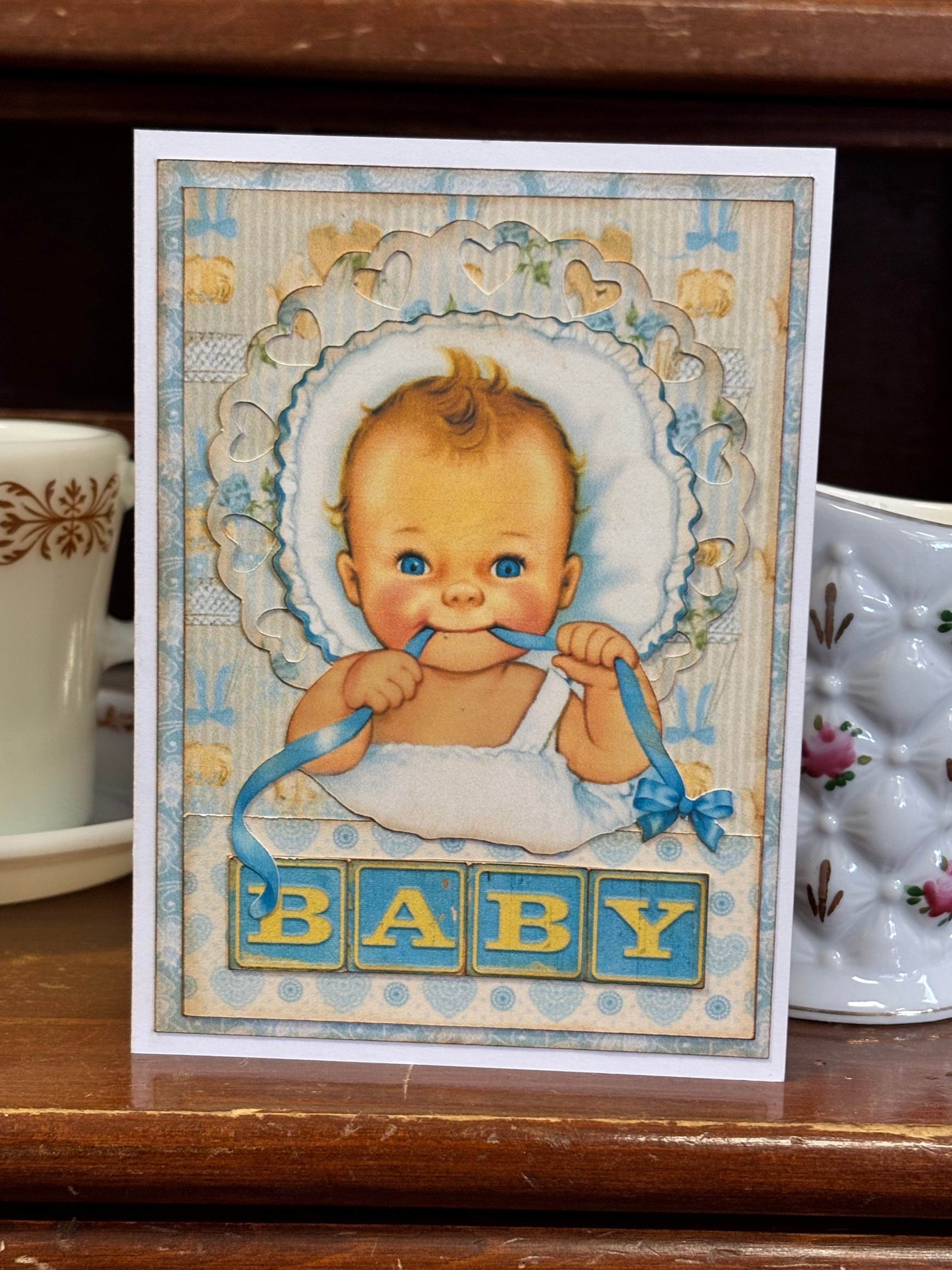 Baby Boy Holding A Ribbon Card